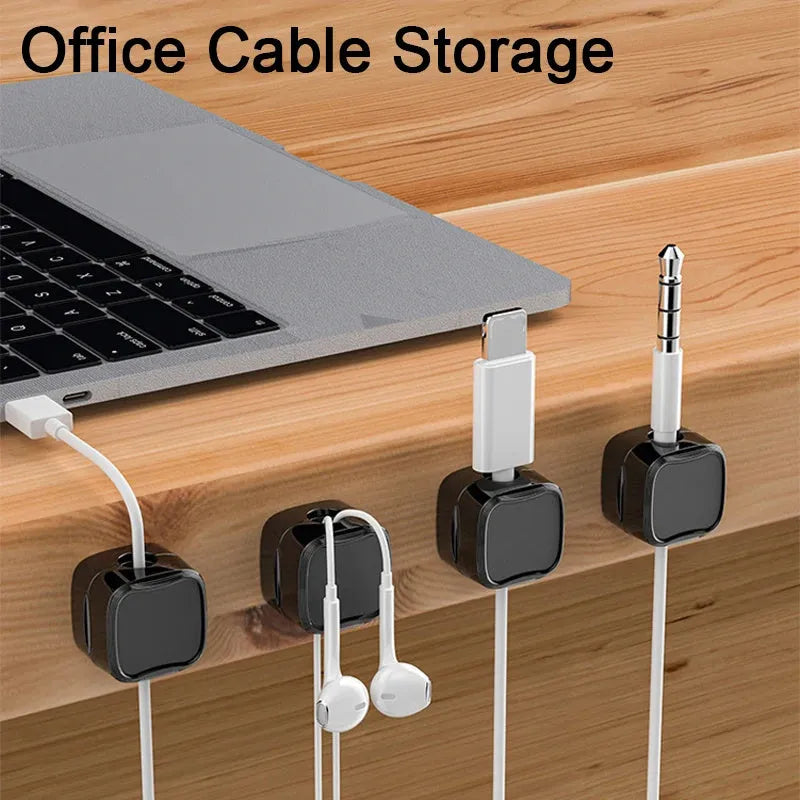 Black and white magnetic cable clips with adhesive backing for under desk cable management.