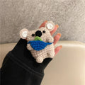 Handmade knitted koala bear backpack-shaped cover for an AirPods charging case.