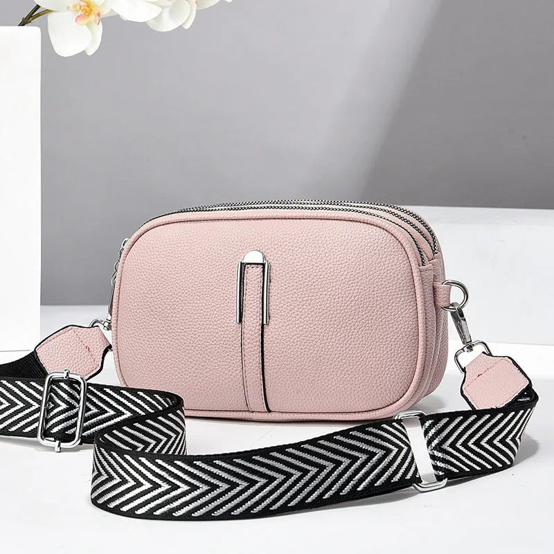 PU leather crossbody shoulder bag in oval shape with multiple internal compartments