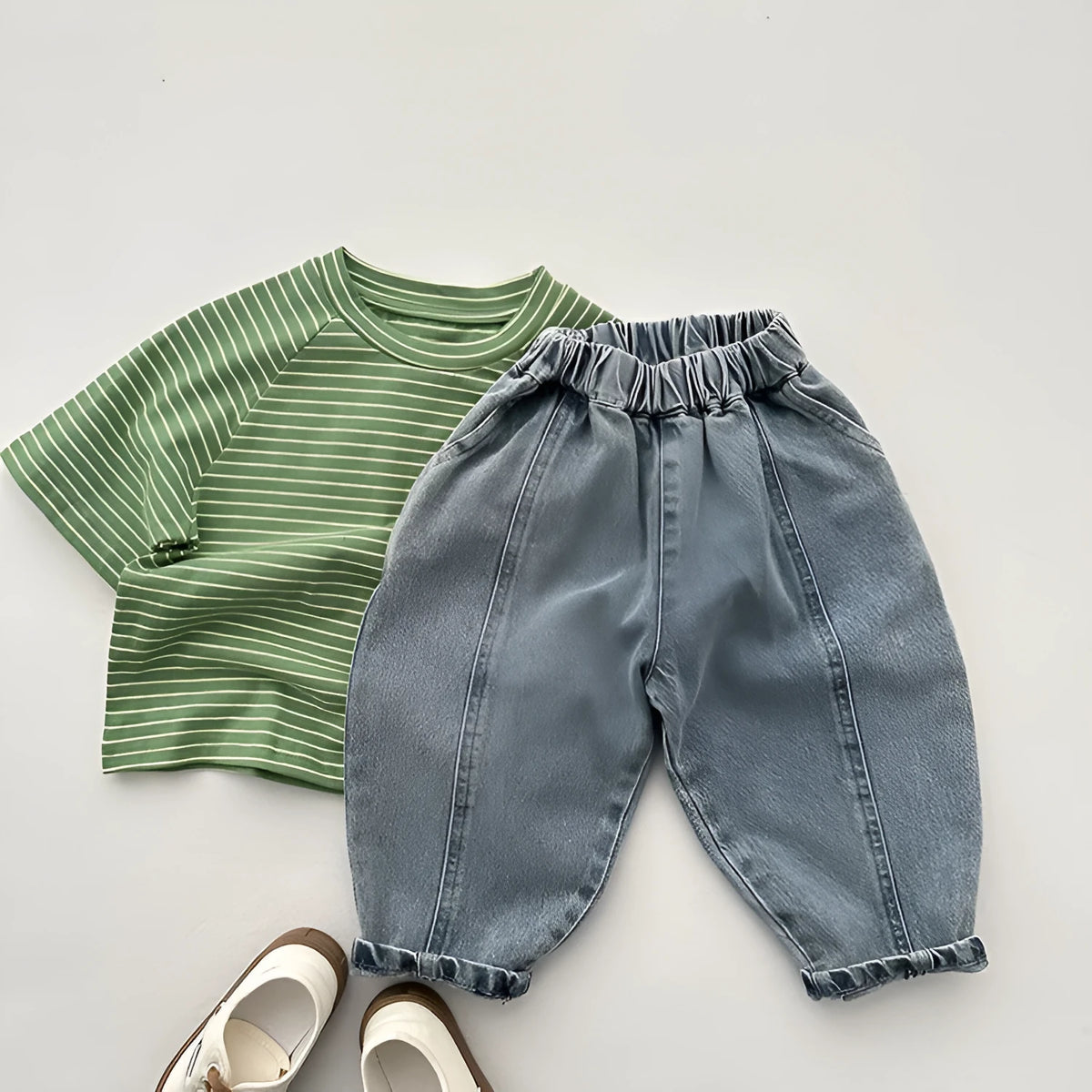 Light blue children's baggy denim jeans with elastic waistband, front view