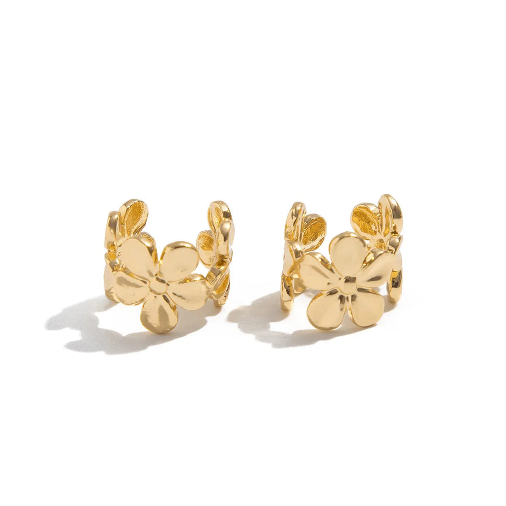 Gold-coloured alloy earrings with starfish and conch designs on a white background.