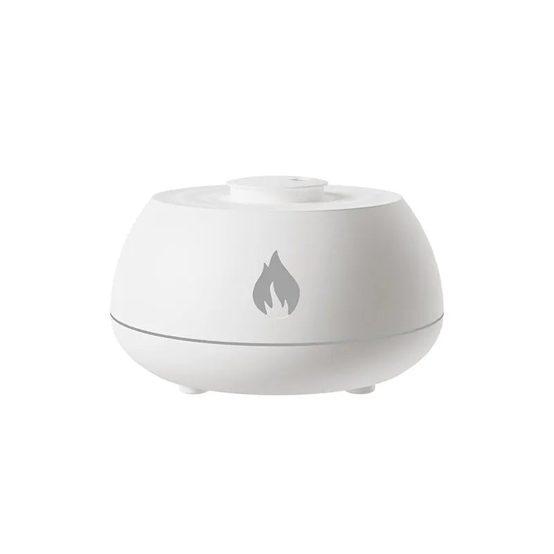 Black and white USB humidifier diffuser with glowing flame effect light on a wooden table.