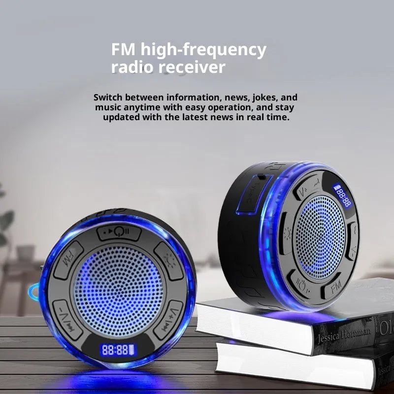 Waterproof Bluetooth speaker with large suction cup in black, mounted on bathroom tile