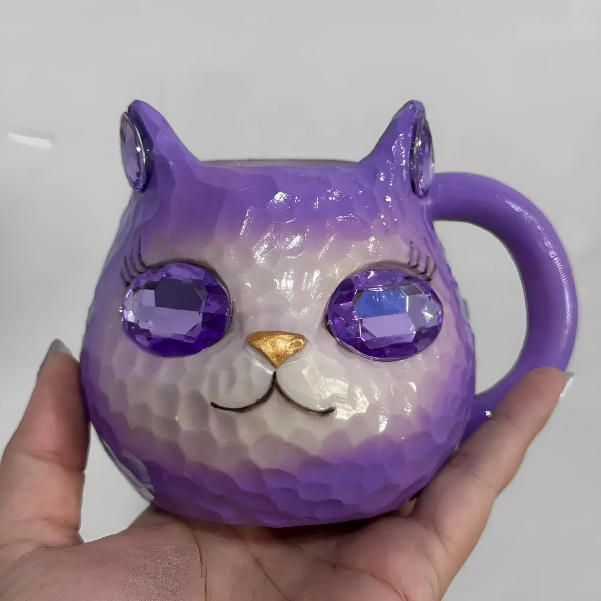 American-style cat cup resin craft ornament in purple, green, blue, and pink colours.