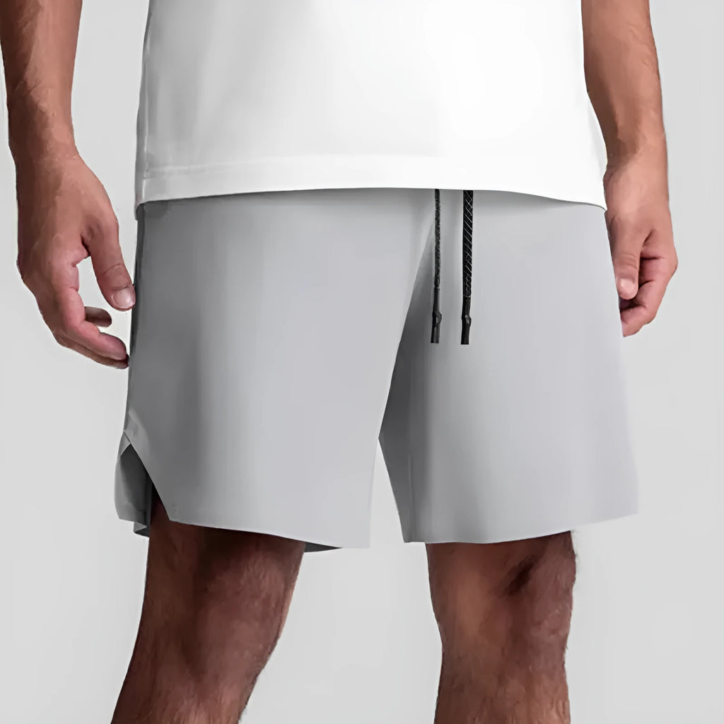 Men's grey seamless sports shorts with knee length and straight cut design for athletic activities