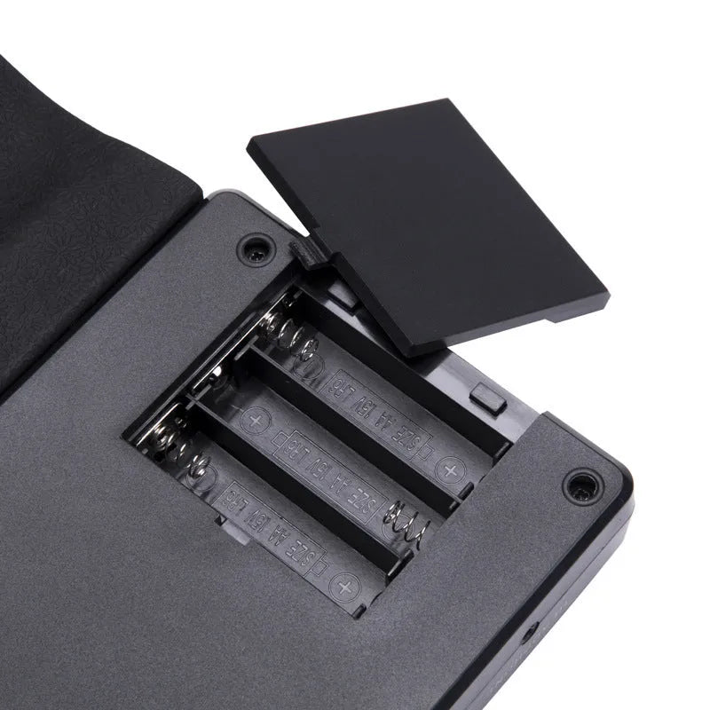 Pearlescent white portable folding electronic keyboard with 49 silicone keys, shown both rolled and unrolled.