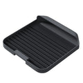 Black cat litter pedal with slanted design and textured grooves for litter containment