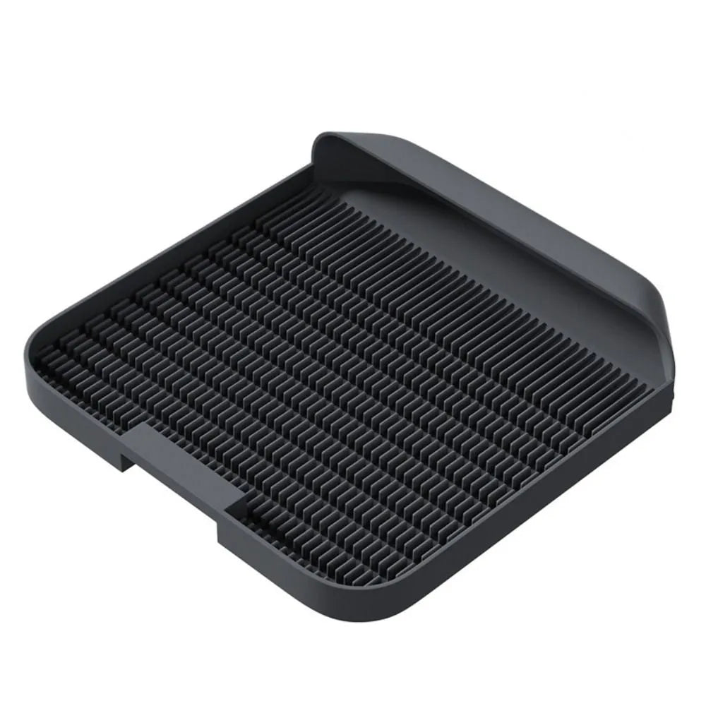 Black cat litter pedal with slanted design and textured grooves for litter containment