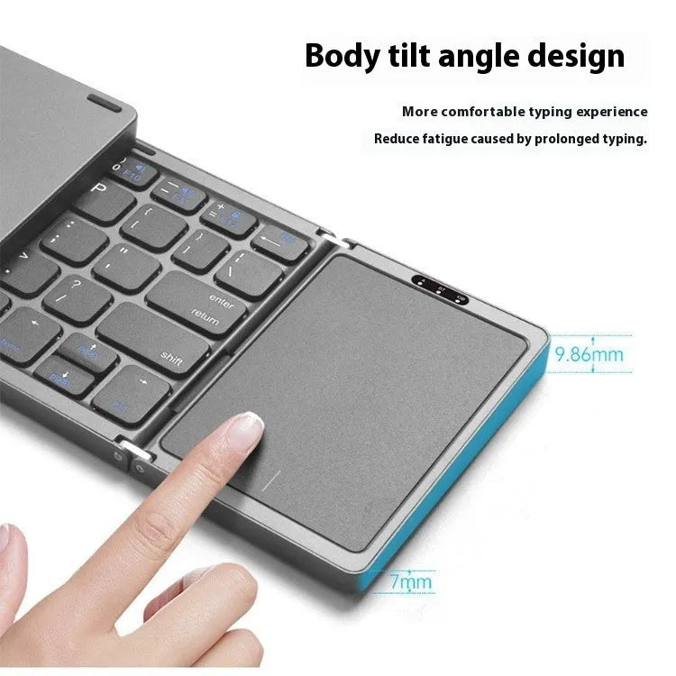 Three folding wireless Bluetooth keyboard with touch pad in black, unfolded on a table