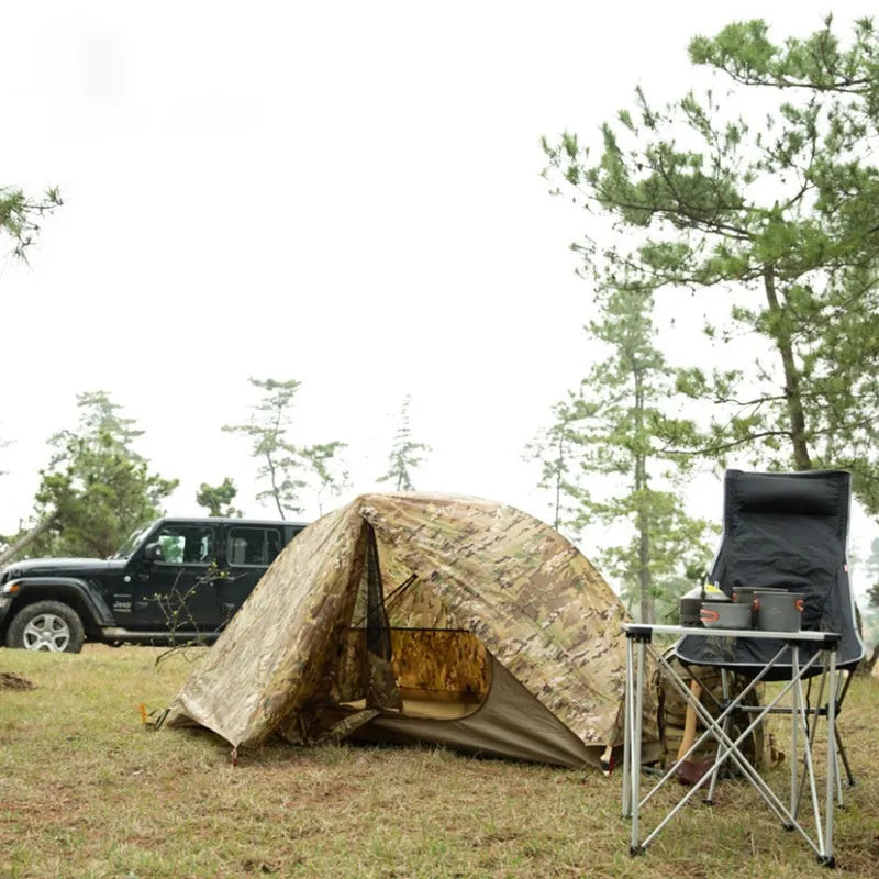 Single soldier camouflage tent shown in outdoor setting with rainproof and sun protection features for camping use