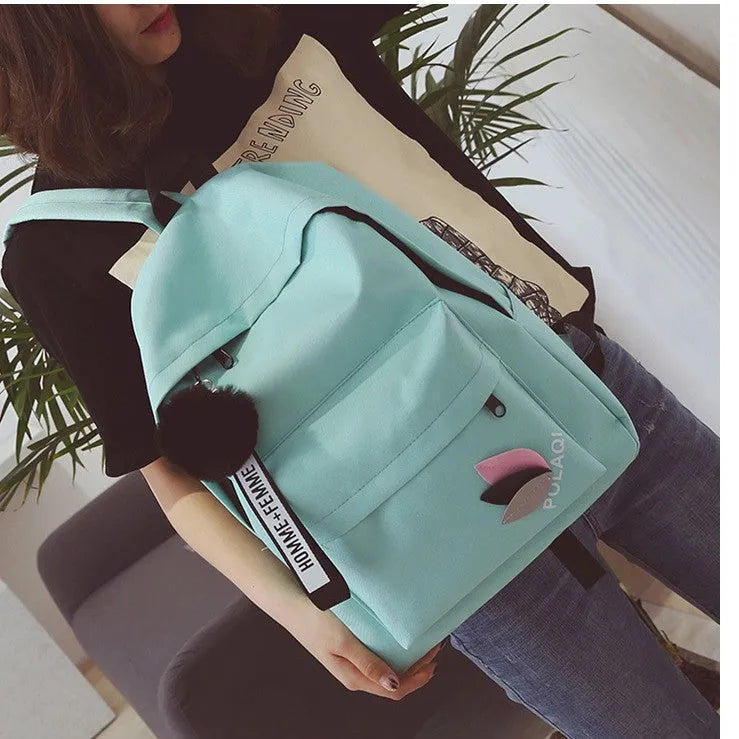 Canvas college backpack with leaf pattern in green colour showing front compartment and straps