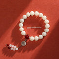 White jade bodhi bracelet with 10mm round seeds and traditional ruyi charm accents