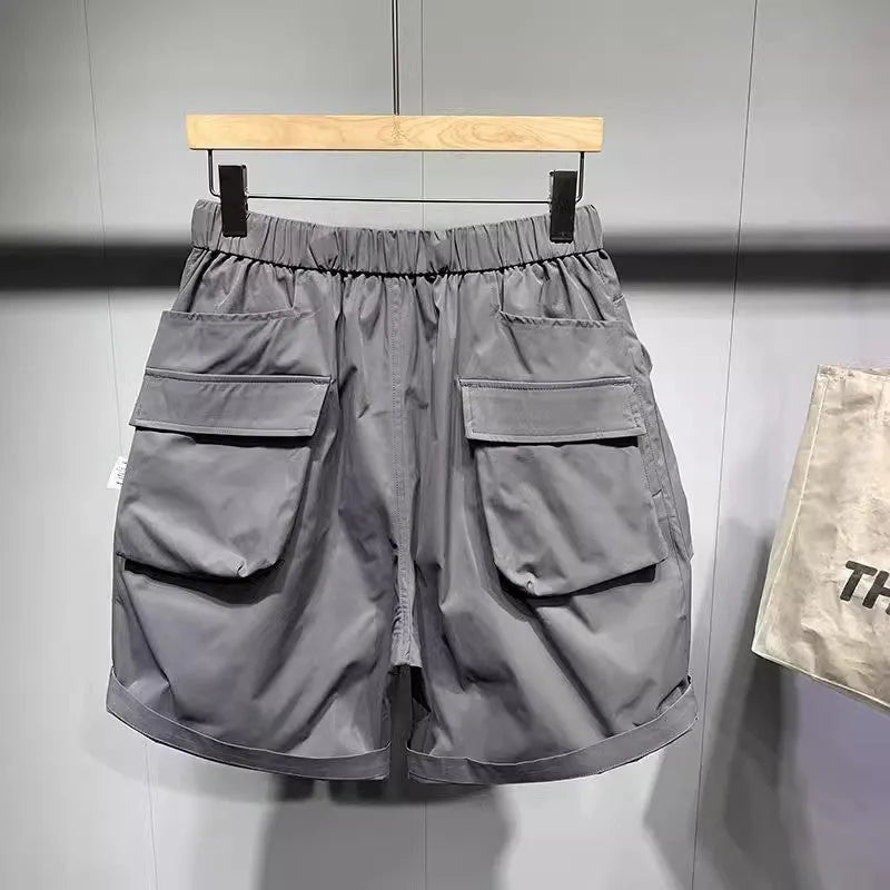 Large size men's work shorts in black with multiple pockets and straight leg design
