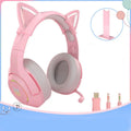 Pink cat ear wired headphones with microphone and LED lights on a stand