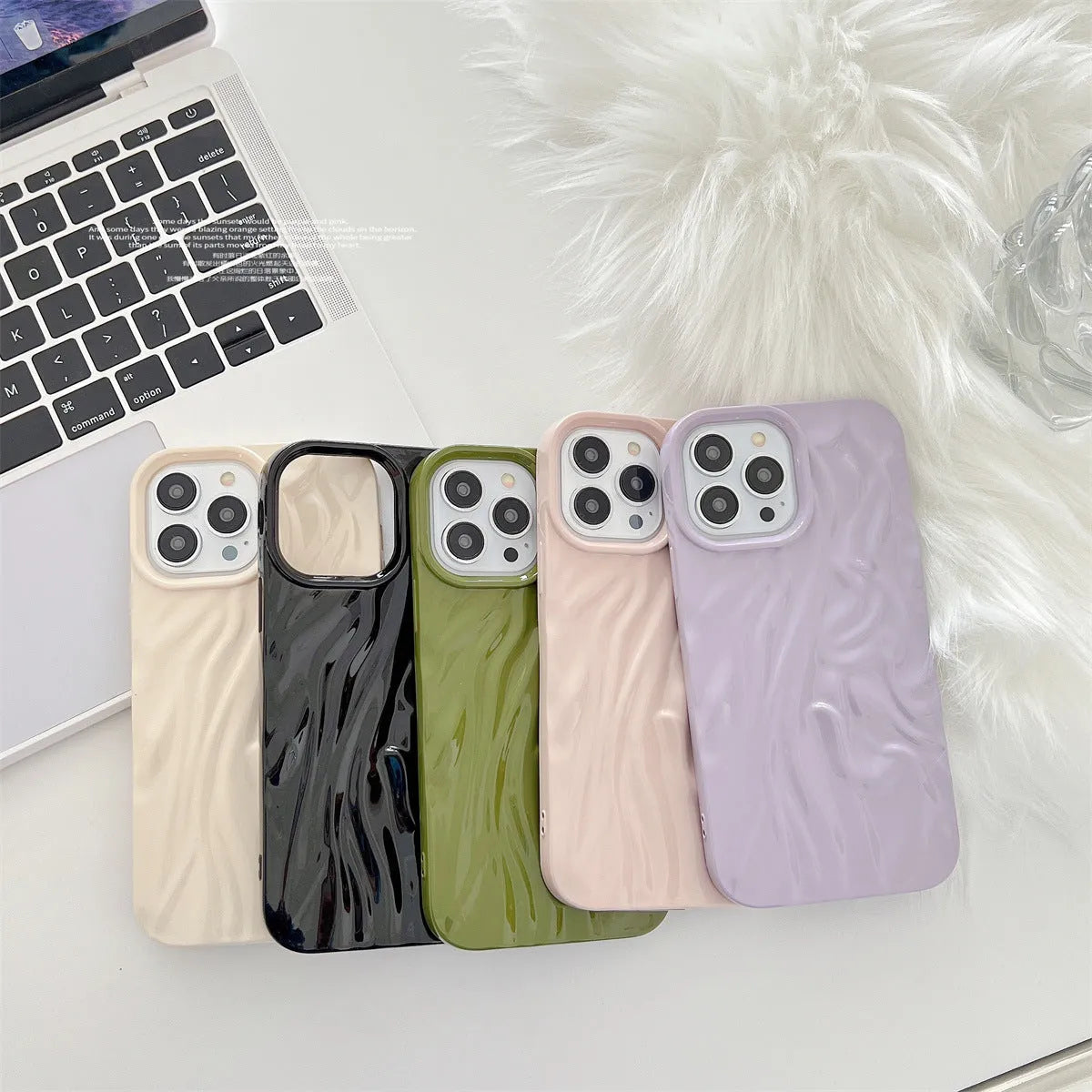 Milky white silicone iPhone case with a water ripple texture on a table.