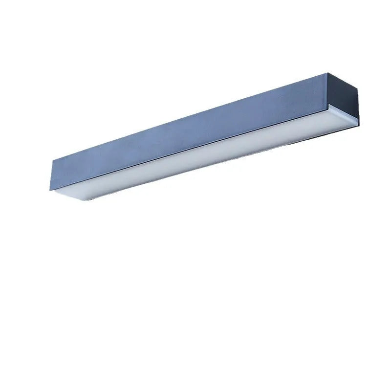 Black solar-powered outdoor wall lamp with integrated solar panel, mounted on a garden wall.