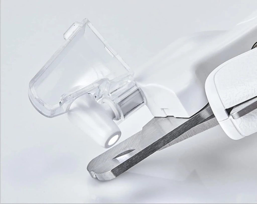 White pet nail clippers with LED light, transparent anti-splash guard, and triangular blade for cats and dogs