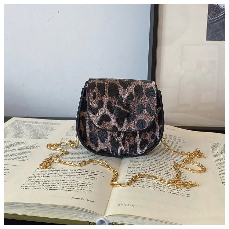 Leopard print mini crossbody saddle bag in PU, horizontal square shape with sandwich pocket, black and reddish brown