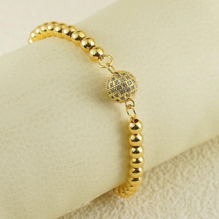 Close-up of a women's heart-shaped copper bracelet with a single round zircon stone, Arabic style.