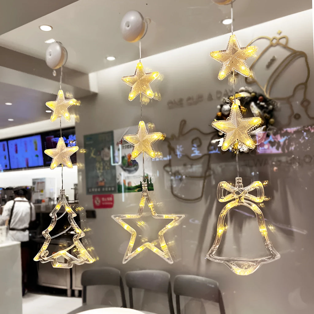 Set of three Christmas LED light pendants with suction cups, showing star, deer, and tree designs on a window.