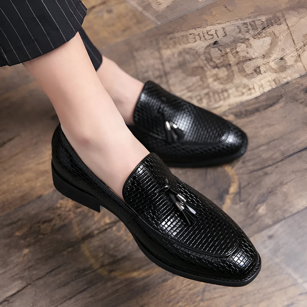 Men's black pointed slip-on business shoes with tassel detail on artificial PU upper