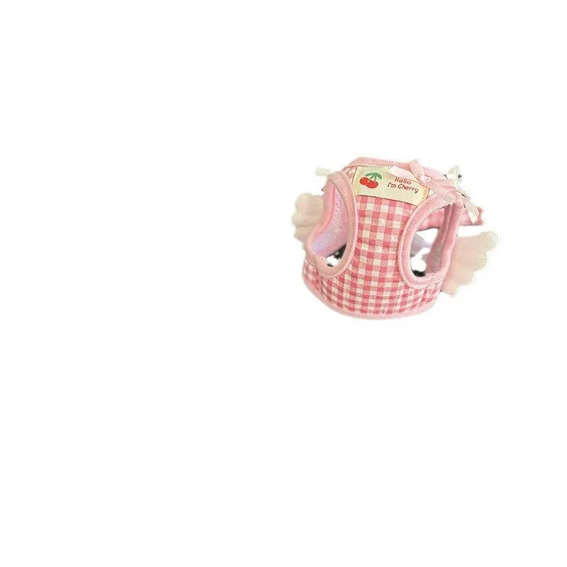 Pink cotton chest and back hand holding rope harness for a small dog on a white background.