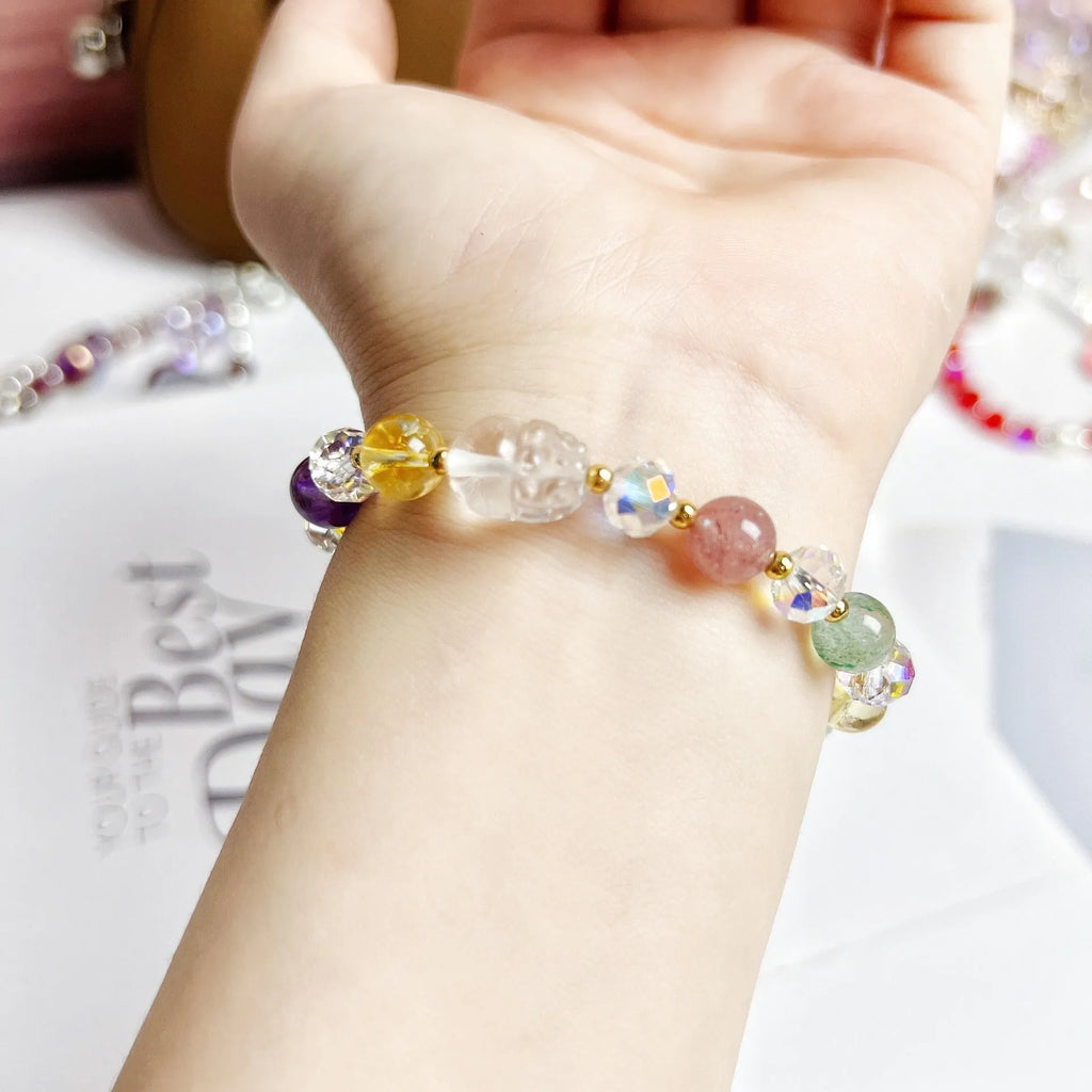 Close-up of a manually crafted crystal bracelet with a nine-tail fox centrepiece on a wrist.