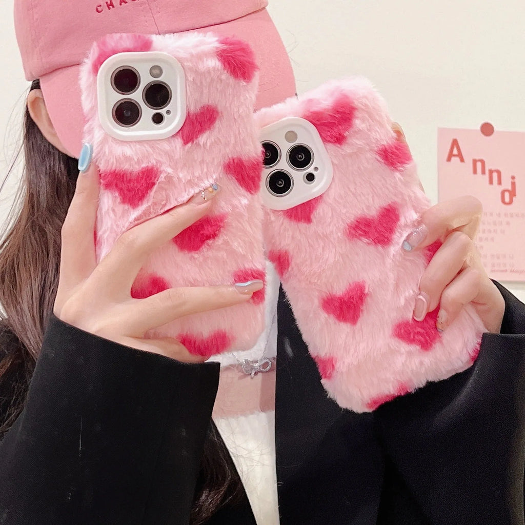 Pink silicone phone case with cartoon design for iPhone models 12, 13, 14, and 15.