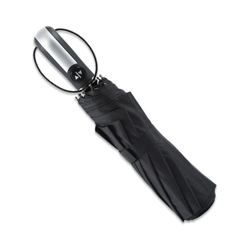 Triple folding automatic open business umbrella in black with steel ribs and a rubber handle.