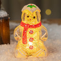 Glowing Christmas gingerbread man snowman ornament with a red scarf, plastic decoration.