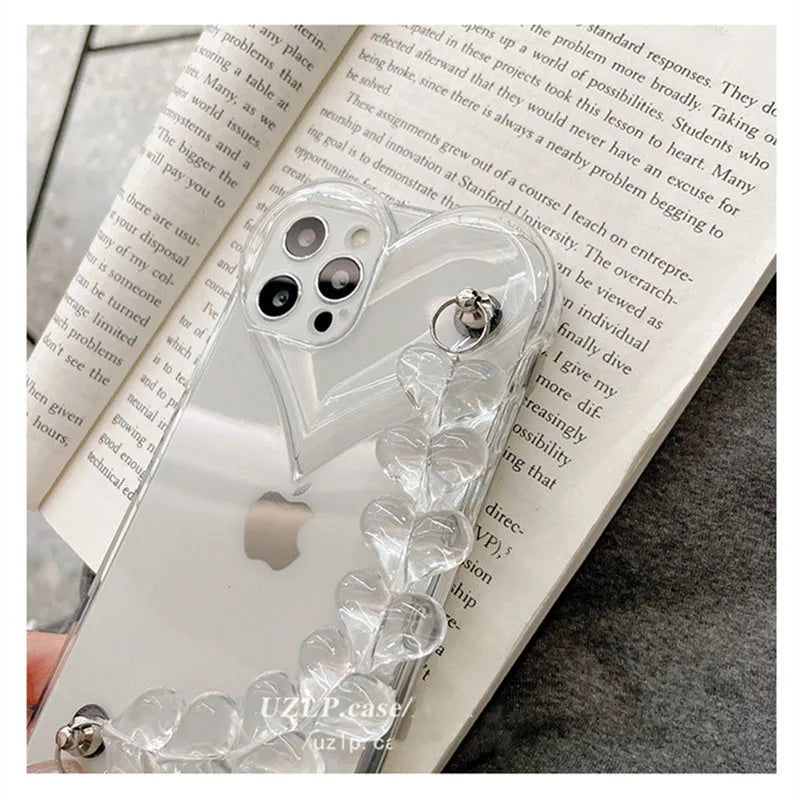 Transparent iPhone case with a love heart and bracelet chain design on a soft TPU background.