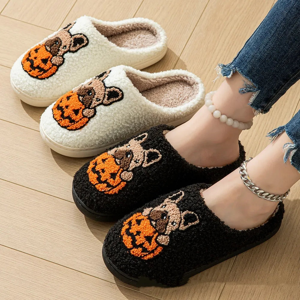 Black and white Halloween plush slippers with pumpkin design, round toe, and textured non-slip TPR soles.