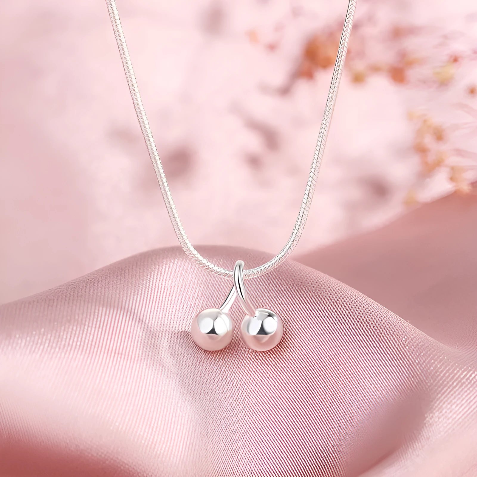 Silver cherry necklace for women with fruit pendant on a snake chain, adjustable length.