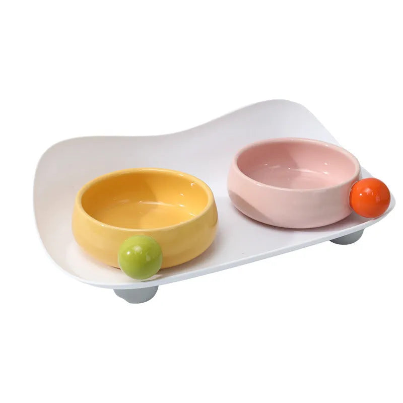Ceramic raised pet feeding bowl set with two bowls and non-slip silicone supports in yellow colour