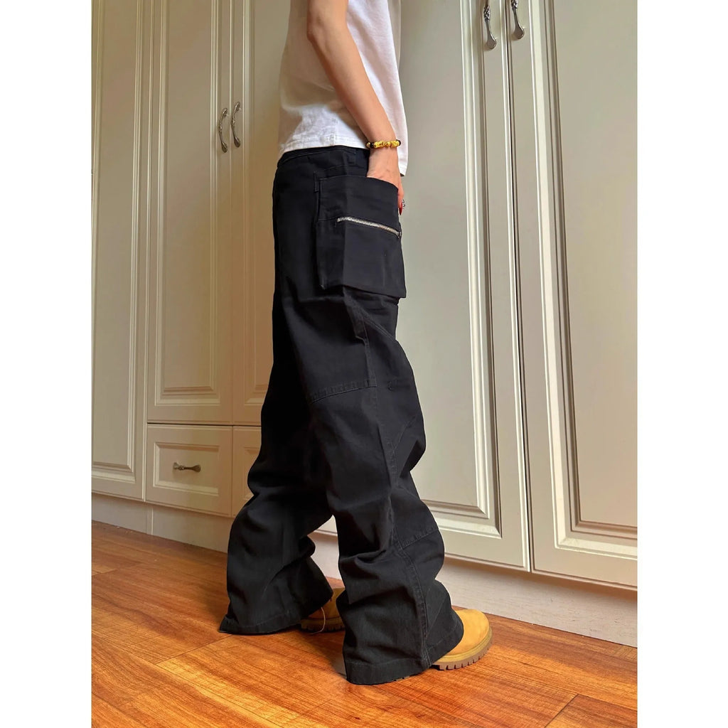 Green and black double zipper casual cotton pants with an elasticated waistband on a hanger.