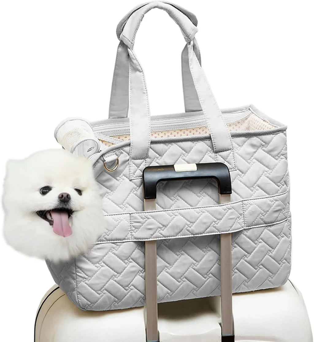 Grey pet carrier handbag with mesh panels and multiple pockets, shown with a small dog inside.