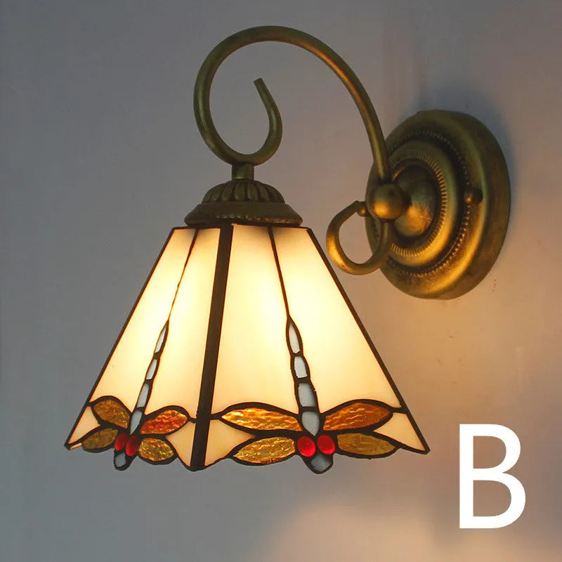 A coloured stained glass wall lamp in a simple contemporary style, mounted on a wall.