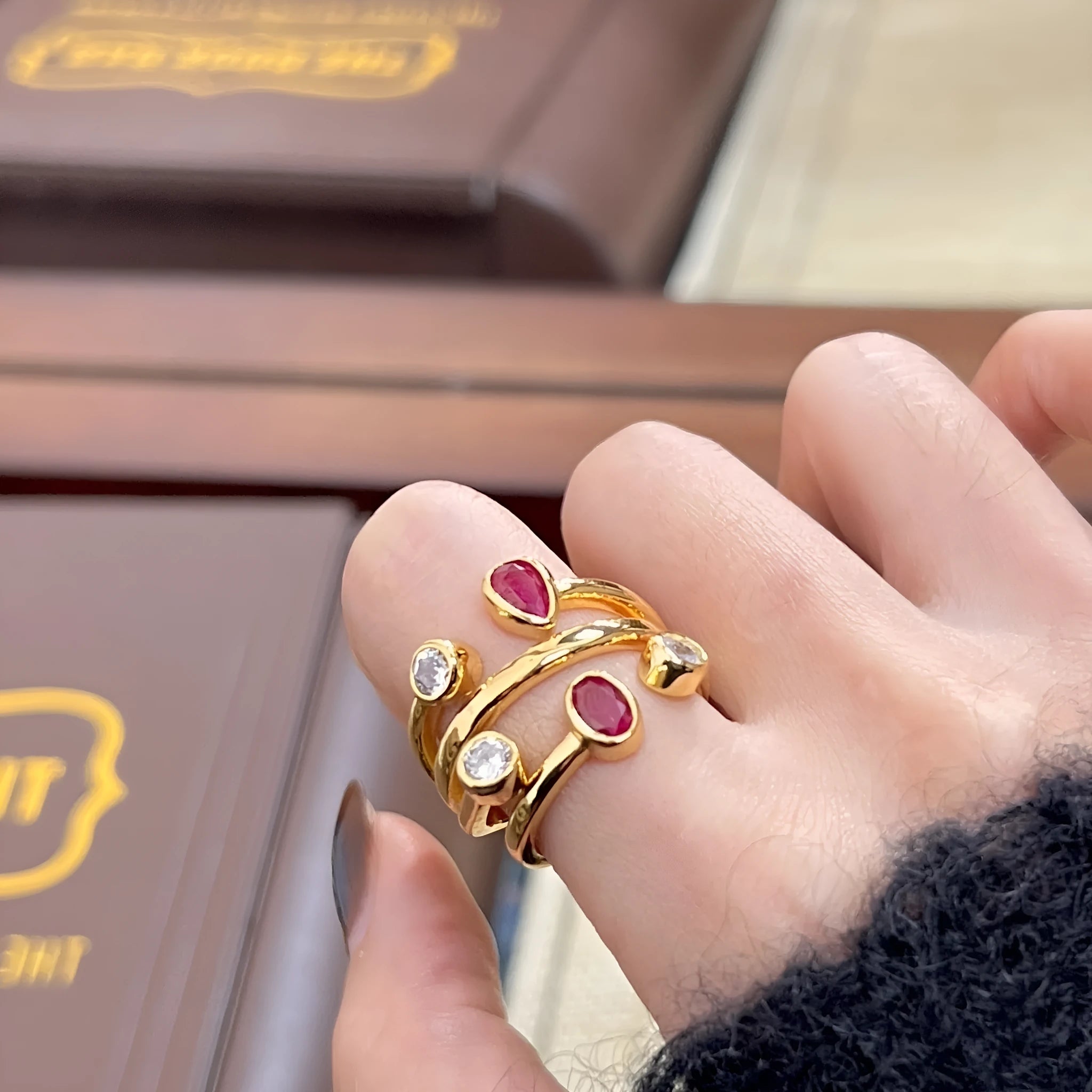 Double-headed copper ring with irregular geometric cross design and group diamonds in two-tone colours.