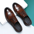 Men's black brogue formal shoes with a lace-up front and perforated detail.