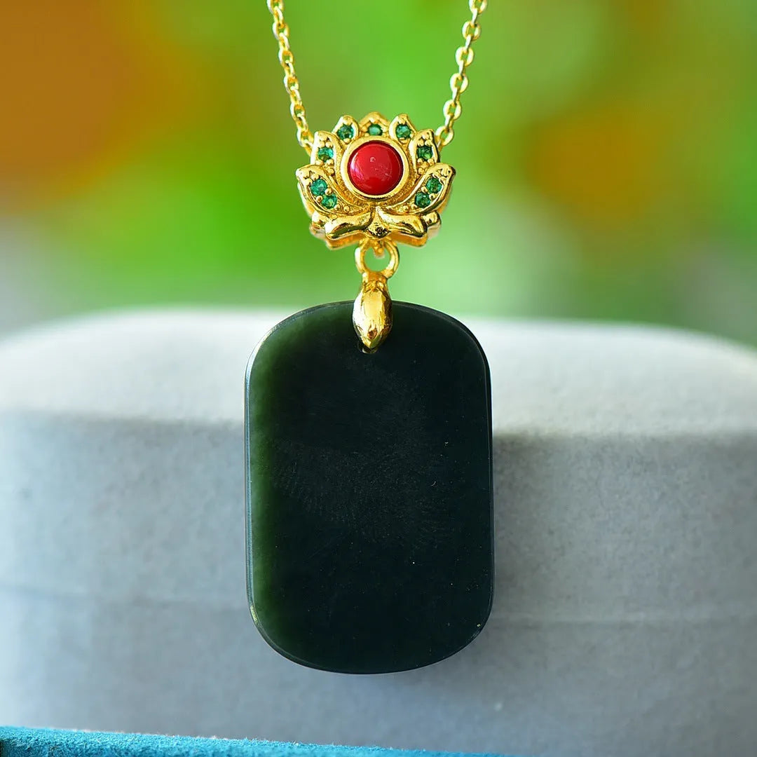 Close-up of a Hetian jade pendant with copper inlay on a necklace chain.