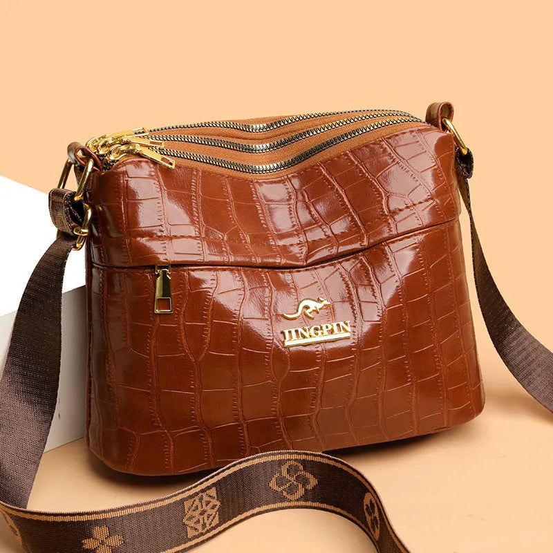 Cross body messenger bag in horizontal square shape with multiple compartments and sandwich pocket construction