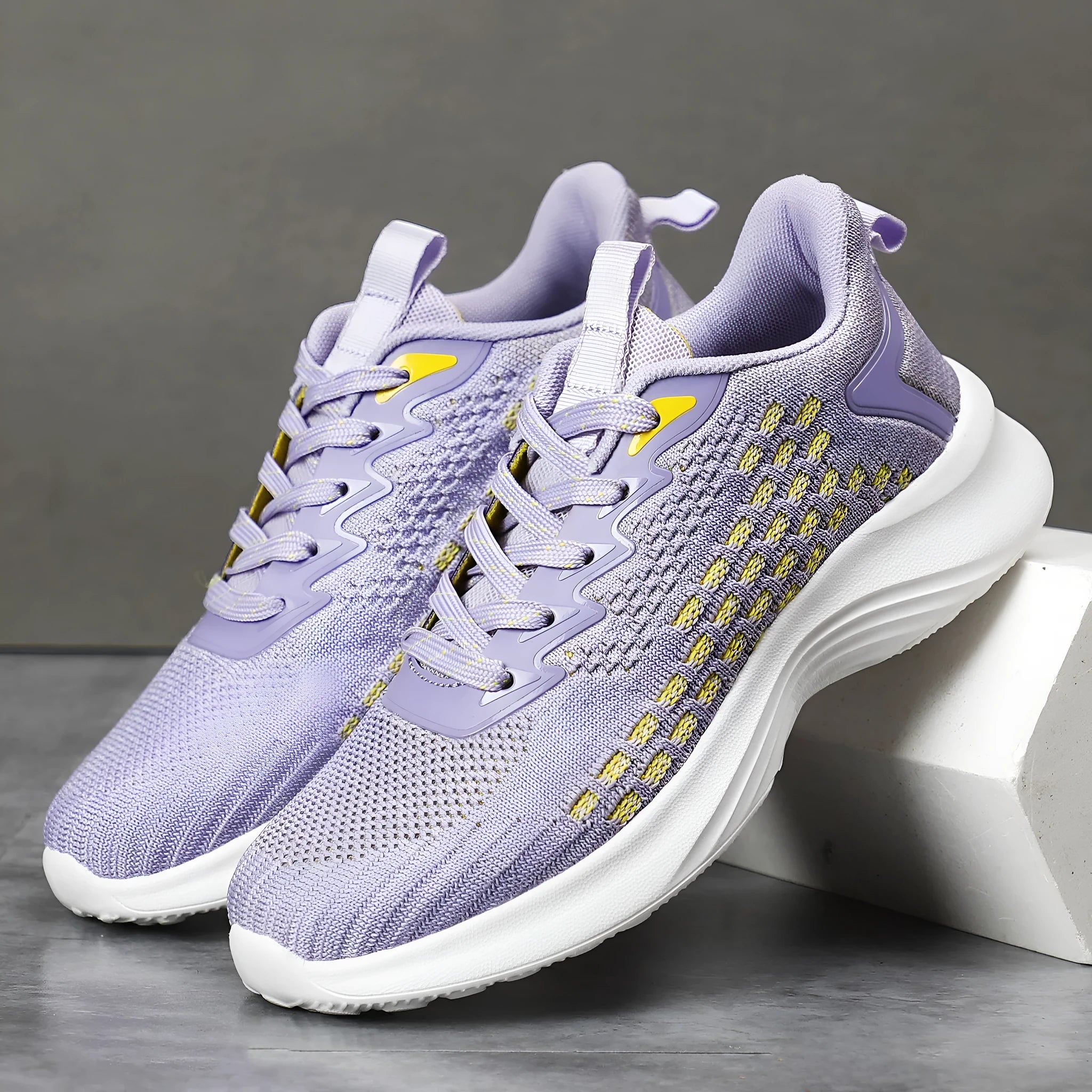 Women's lavender purple Flyknit running shoes with mesh upper and EVA sole on a white background.