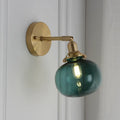 Creative pumpkin-shaped wall lamp with hand-blown water ripple glass shade mounted on a brushed nickel bracket.