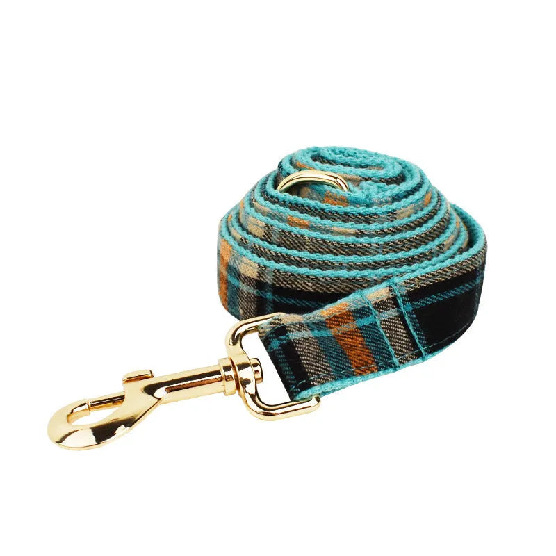 Green cloth dog collar and leash set with matching vest and bow accessory in four-piece pet package