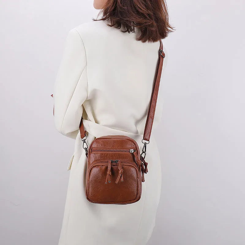 Women's soft PU leather mini shoulder bag with chain strap, square vertical shape, plain black finish, zipper closure