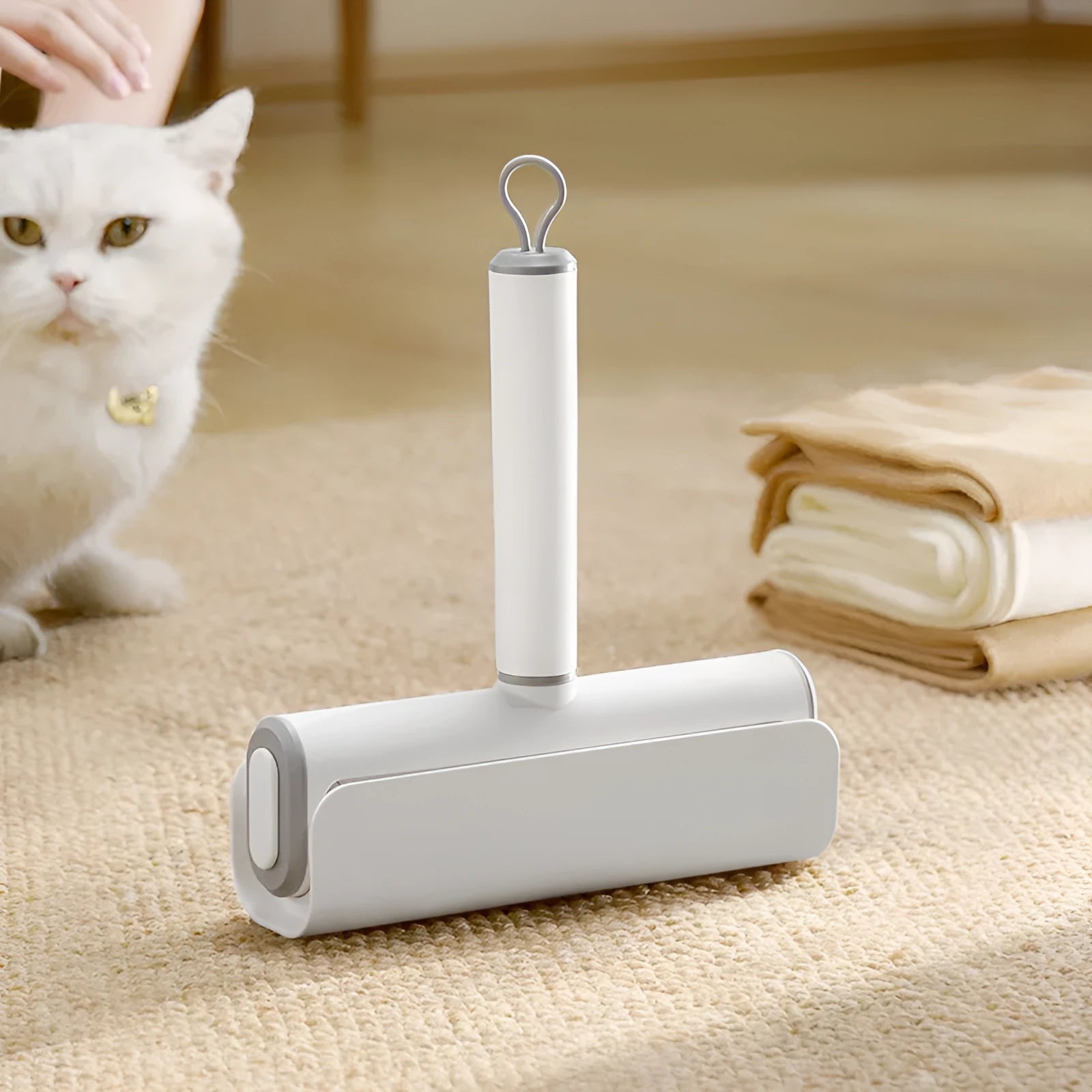 Handheld pet hair lint roller with a sticky paper surface on a yellow core.
