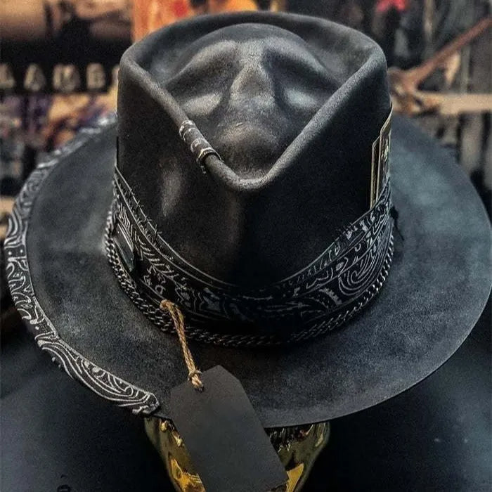 Handmade black wool felt skull hat with a tall pointed conical crown for Halloween costumes.