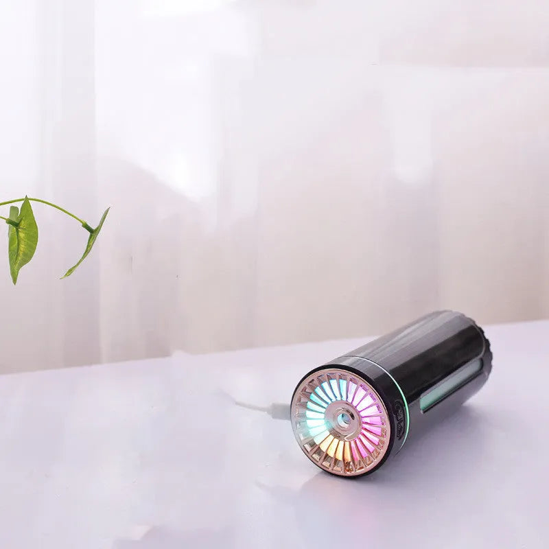 Black USB car humidifier with LED lights placed in vehicle cup holder showing mist output