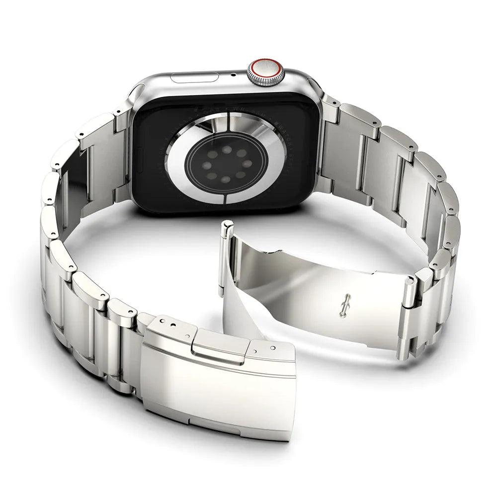 Black titanium metal band with folding buckle for Apple Watch on a grey background