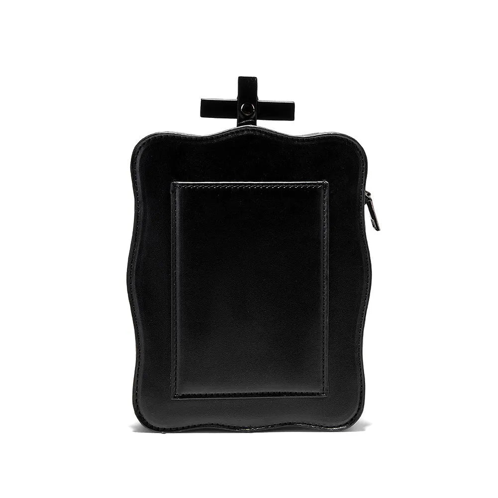Black vertical square mini crossbody bag with embossed skull design, metal rivets, and chain strap.